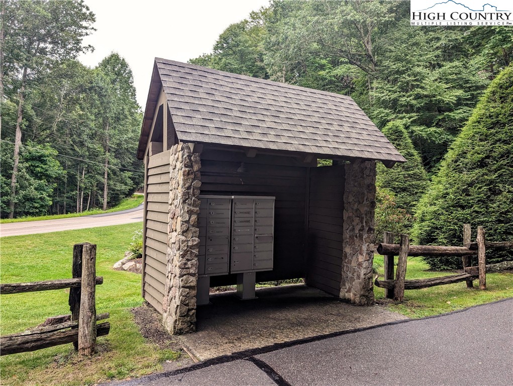Daisy Ridge Road, Unit 1 2) Banner Elk, NC 28604 - Photo 2 of 6 a view of a house with a yard porch and wooden fence