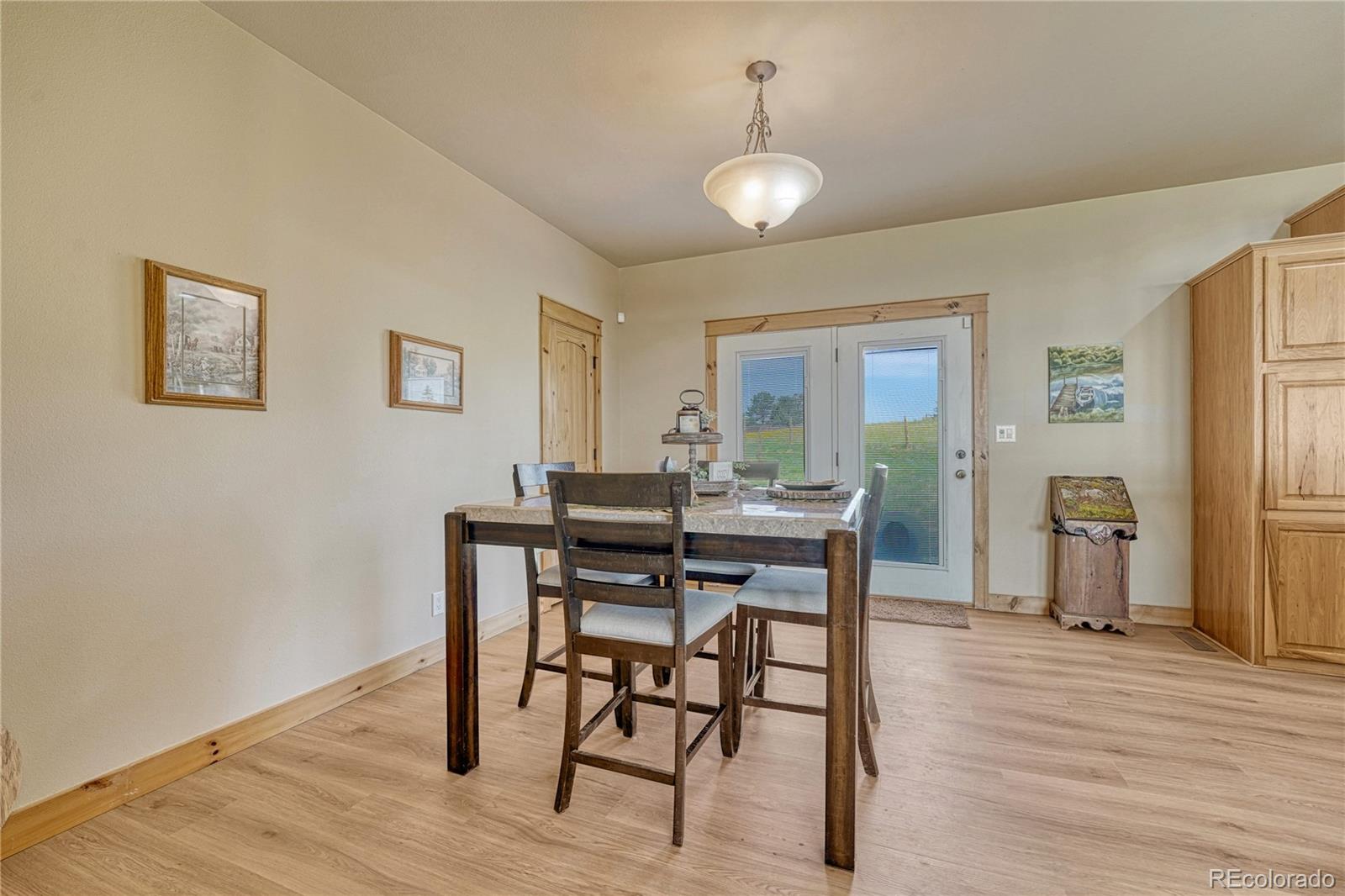 17355 Wagon Train Loop Peyton, CO 80831 - Photo 13 of 48 a view of a dining room with furniture and wooden floor