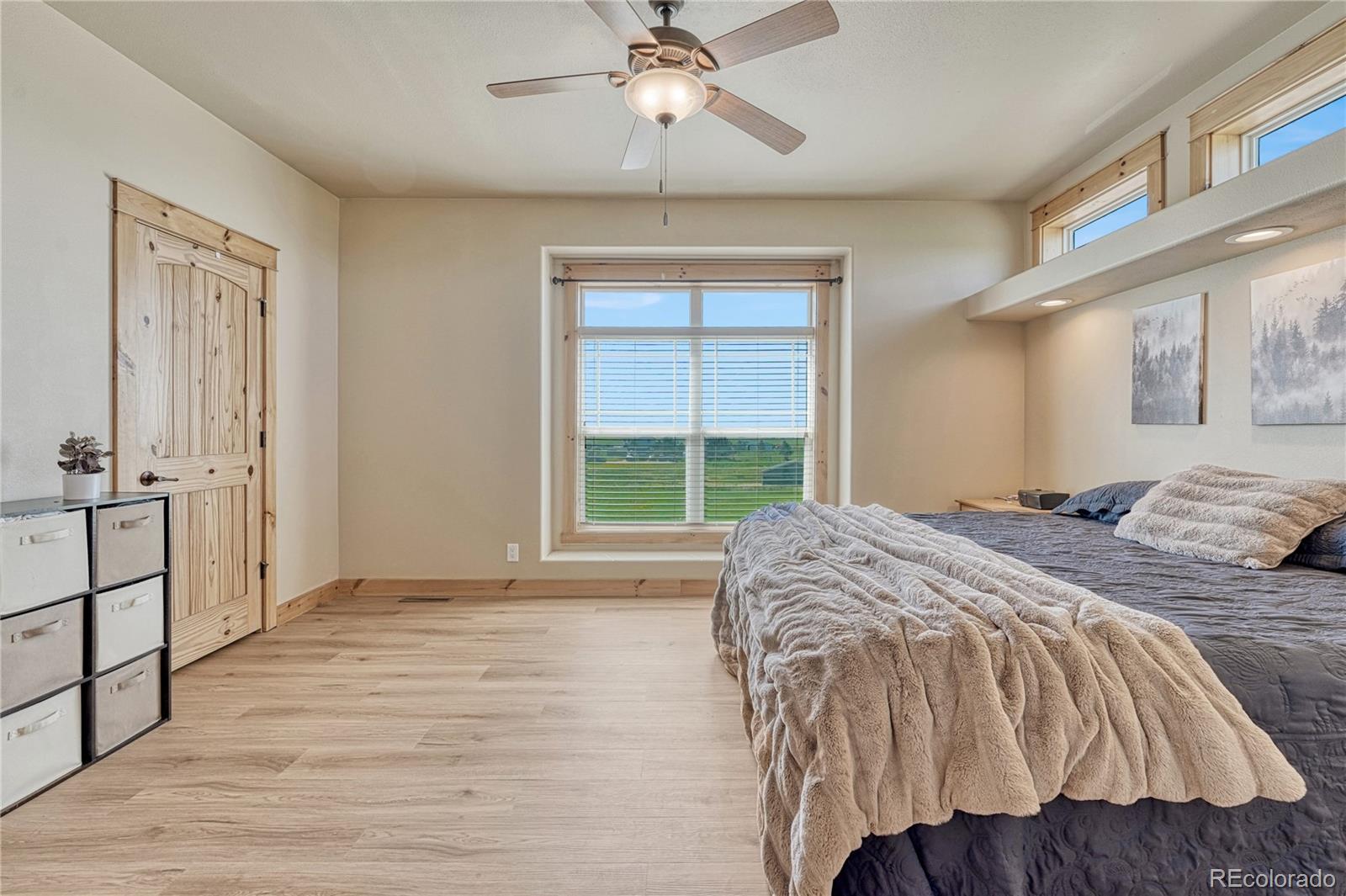 17355 Wagon Train Loop Peyton, CO 80831 - Photo 16 of 48 a bed sitting in a bedroom next to a window