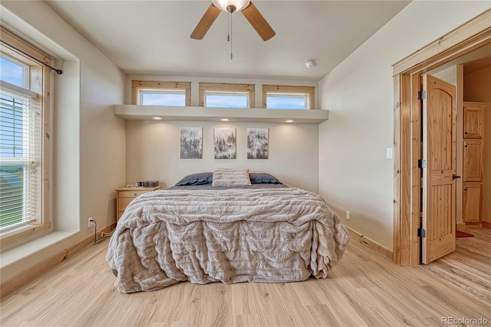 17355 Wagon Train Loop Peyton, CO 80831 - Photo 17 of 48 a bedroom with a bed and wooden floor