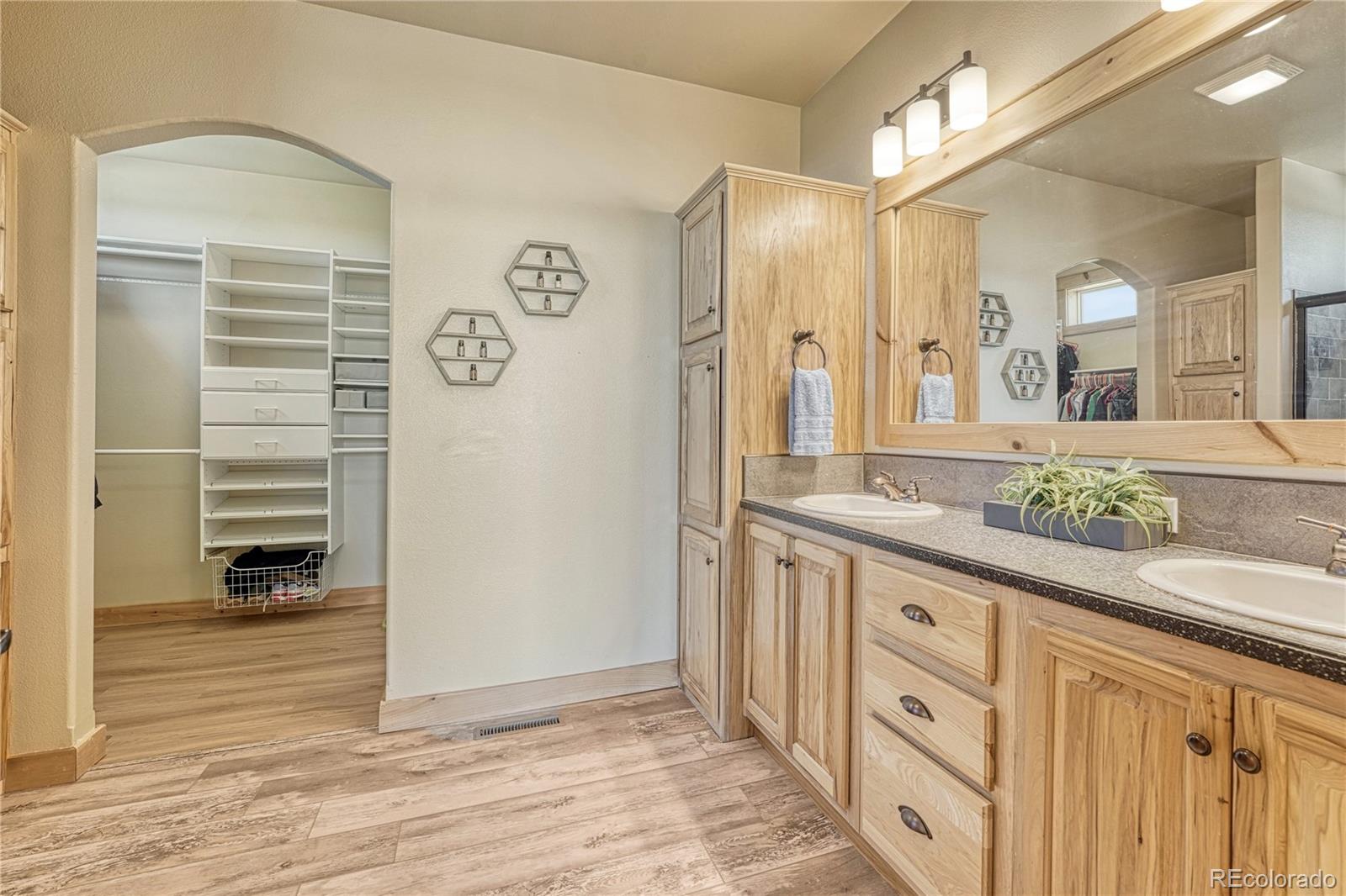 17355 Wagon Train Loop Peyton, CO 80831 - Photo 19 of 48 a bathroom with a sink and a mirror