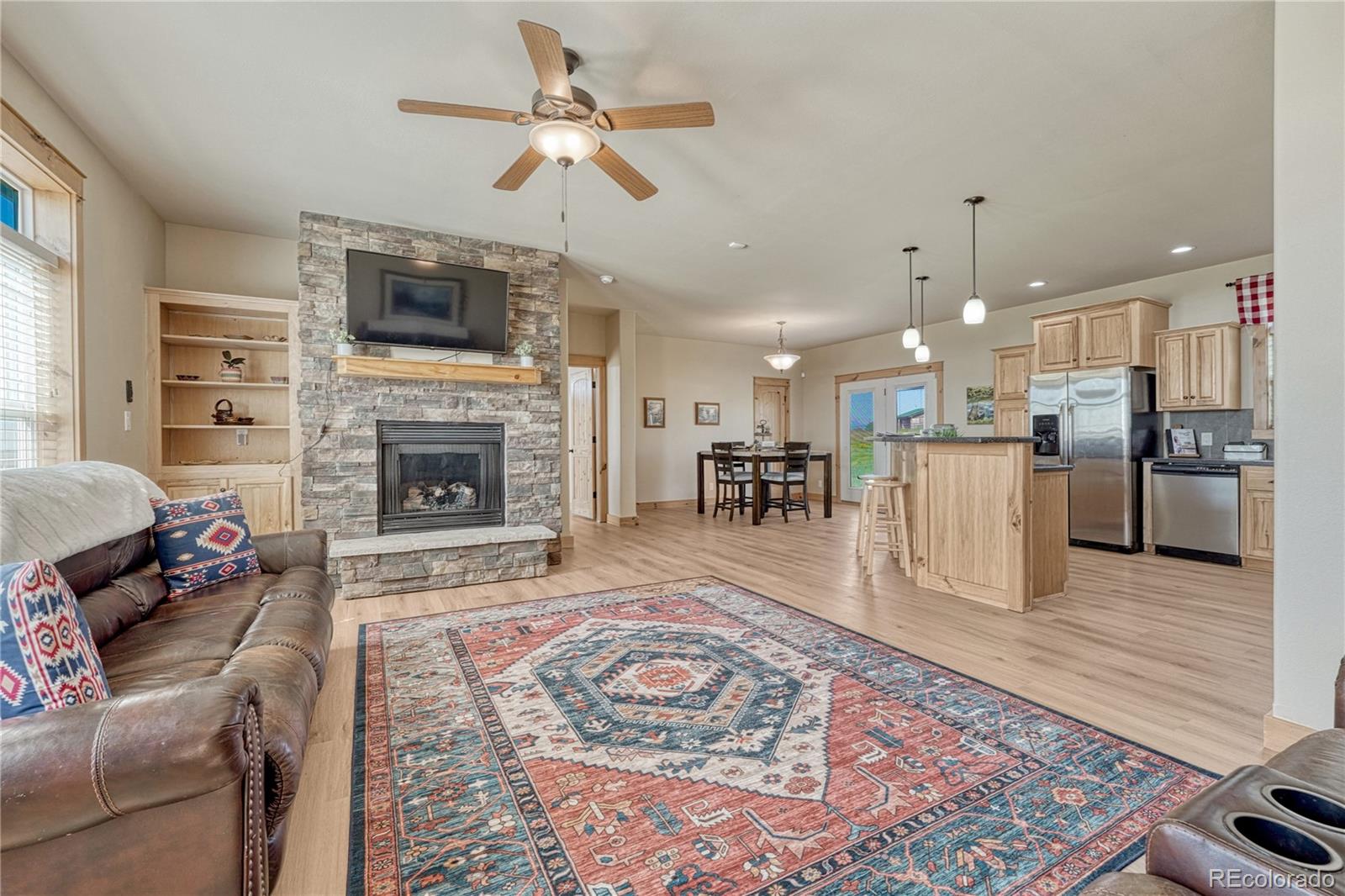17355 Wagon Train Loop Peyton, CO 80831 - Photo 2 of 48 a living room with furniture fireplace and flat screen tv