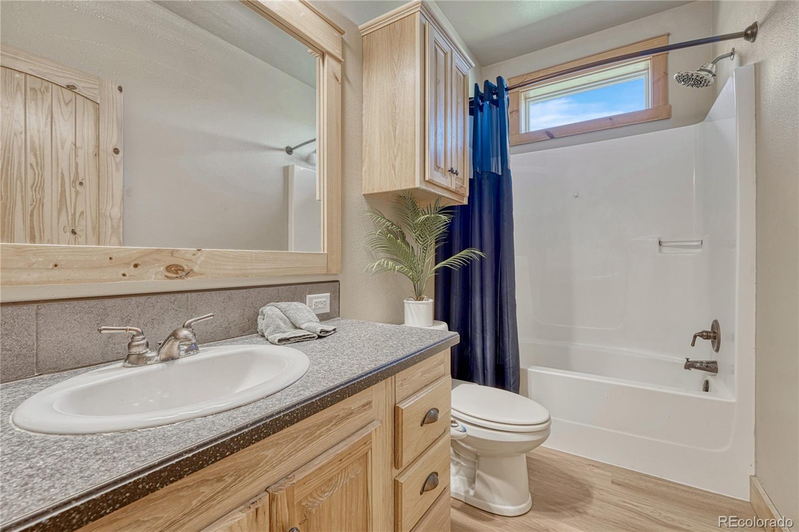 17355 Wagon Train Loop Peyton, CO 80831 - Photo 26 of 48 a bathroom with a granite countertop sink toilet and shower