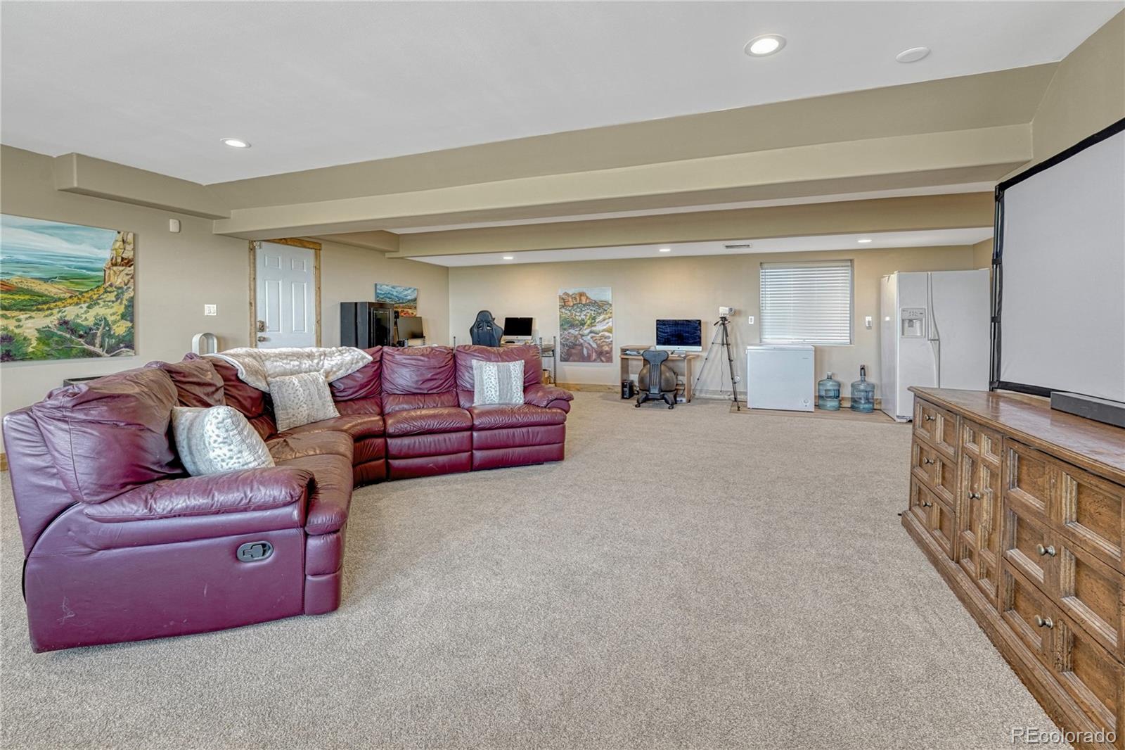 17355 Wagon Train Loop Peyton, CO 80831 - Photo 32 of 48 a living room with furniture and a flat screen tv