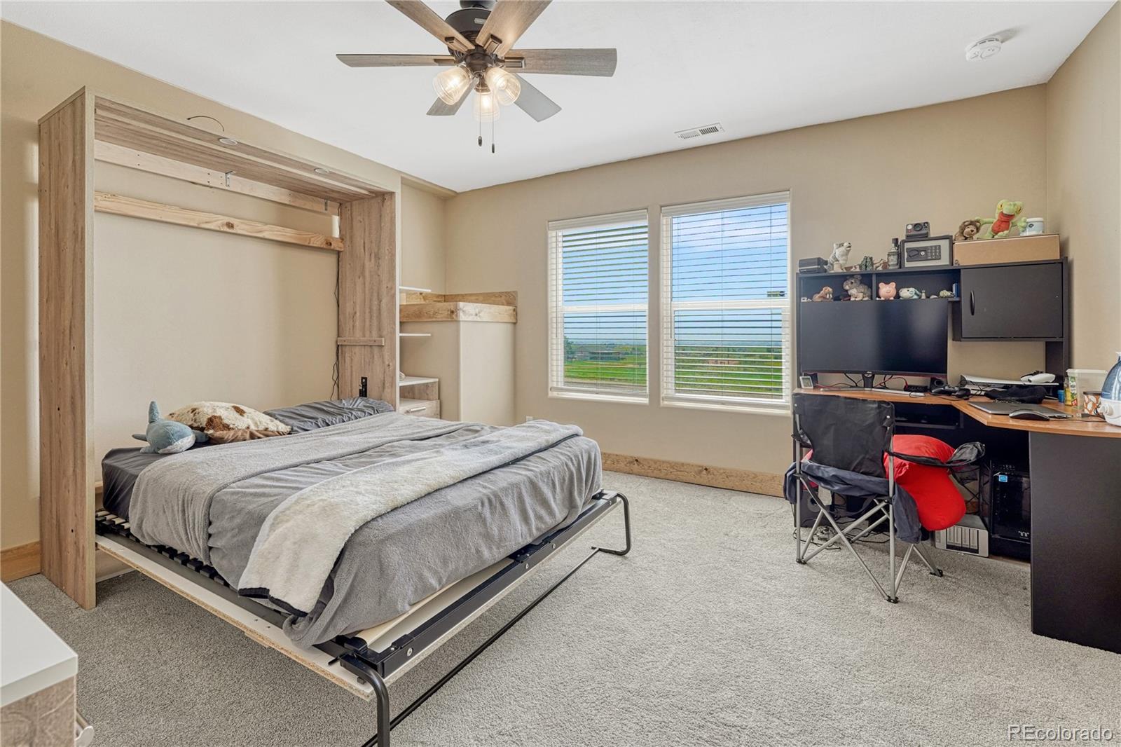 17355 Wagon Train Loop Peyton, CO 80831 - Photo 33 of 48 a bedroom with a bed and a desk