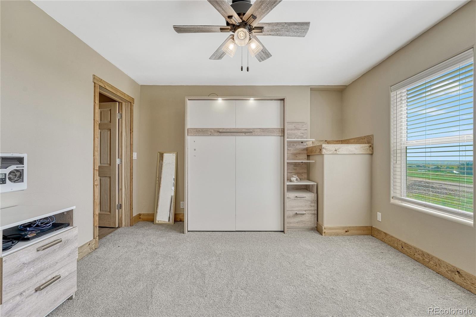 17355 Wagon Train Loop Peyton, CO 80831 - Photo 35 of 48 an empty room with windows and cabinet