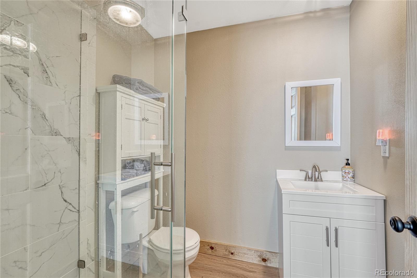 17355 Wagon Train Loop Peyton, CO 80831 - Photo 36 of 48 a bathroom with a sink a toilet and shower