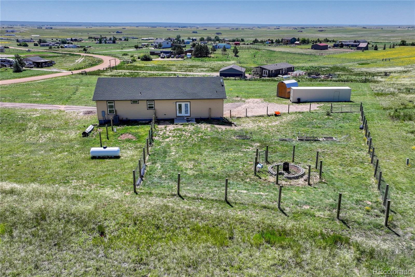 17355 Wagon Train Loop Peyton, CO 80831 - Photo 46 of 48 an aerial view of a house with garden space and mountain view in back