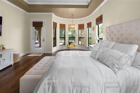 a spacious bedroom with a large bed and a large window