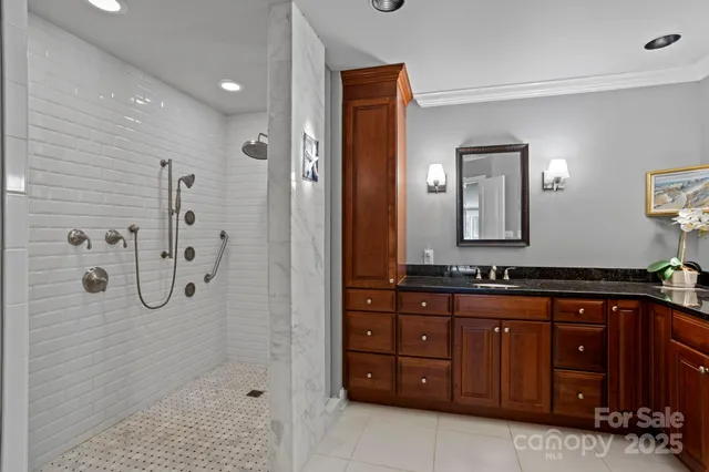 a spacious bathroom with a granite countertop sink mirror and shower