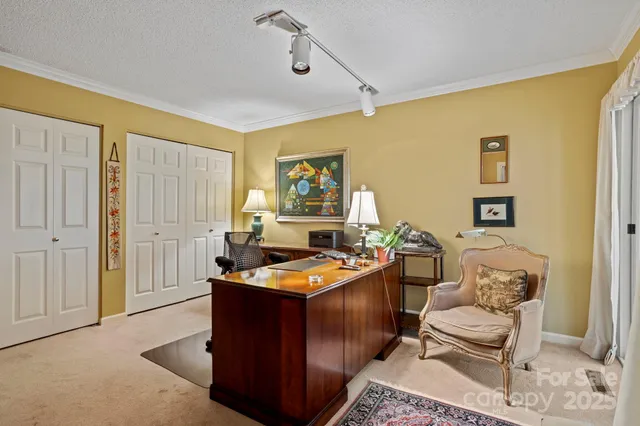 a room with stainless steel appliances kitchen island granite countertop furniture and a wooden floor