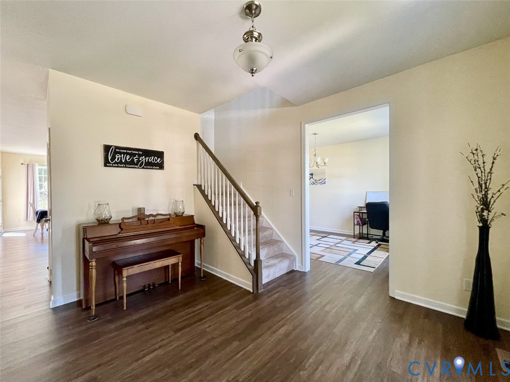 9506 Simonsville Road Midlothian, VA 23112 - Photo 5 of 27 a view of a hallway with wooden floor and staircase