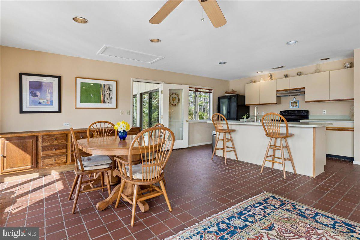 10087 John Carvill Road Chestertown, MD 21620 - Photo 17 of 63 a kitchen with stainless steel appliances kitchen island granite countertop a table chair and a refrigerator