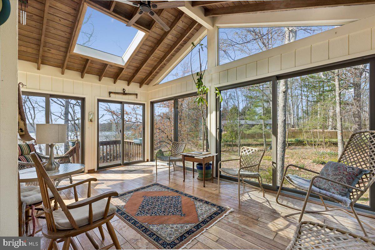 10087 John Carvill Road Chestertown, MD 21620 - Photo 18 of 63 a living room with furniture and a floor to ceiling window