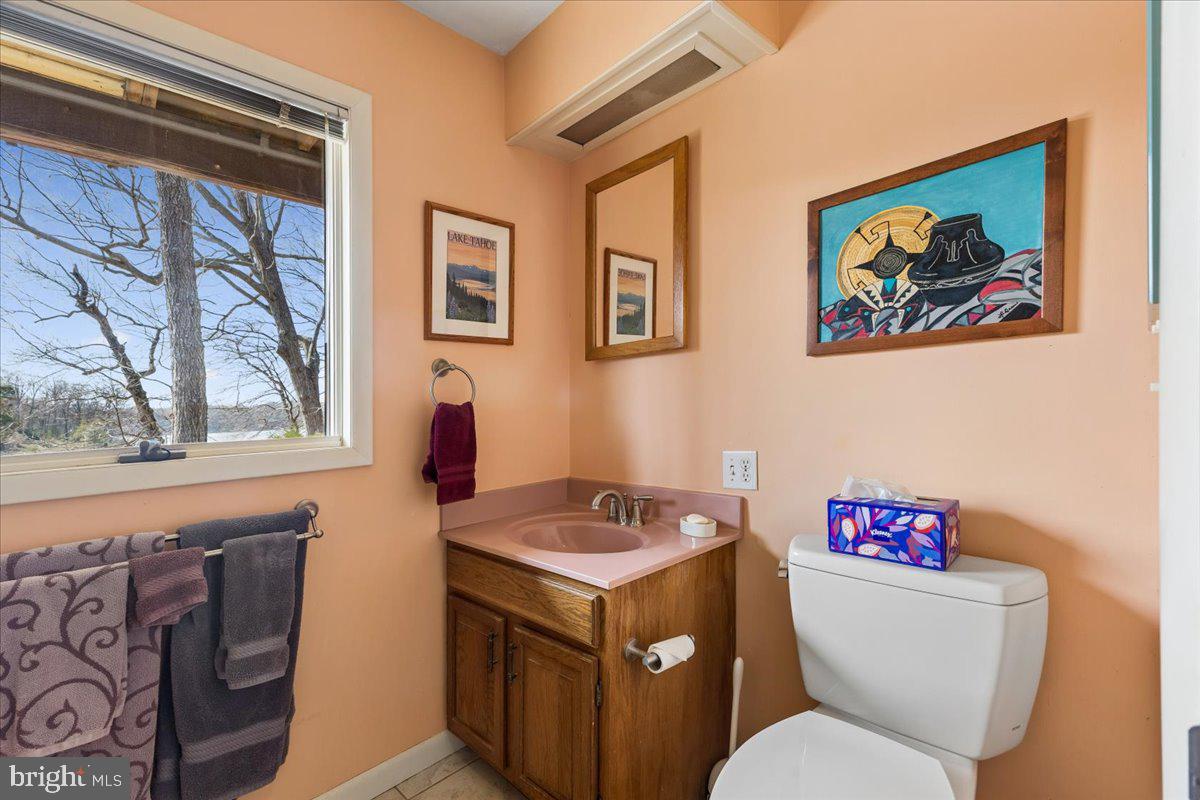 10087 John Carvill Road Chestertown, MD 21620 - Photo 37 of 63 a bathroom with a toilet a sink and a window