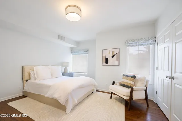 a bedroom with a bed and a table