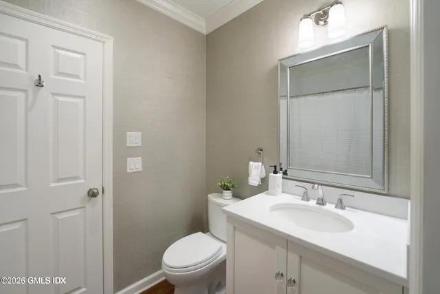 a bathroom with a sink toilet and vanity