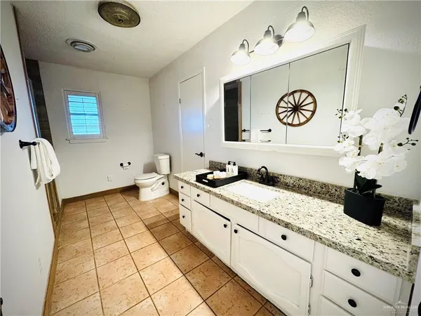 a view of a kitchen with cabinets and wooden floor