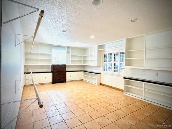 a bathroom with a granite countertop double vanity sink a mirror and bathtub