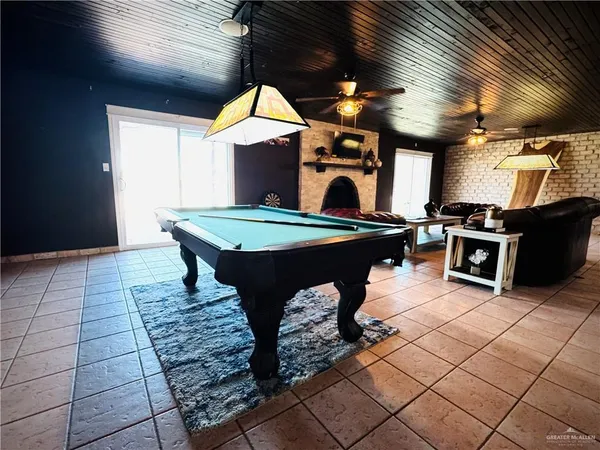 a living room with a fireplace furniture and a flat screen tv