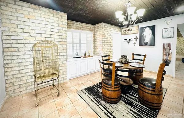 a view of a dining room with furniture and chandelier