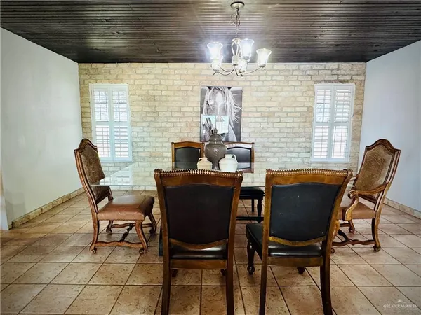 a kitchen with stainless steel appliances kitchen island granite countertop a stove a sink dishwasher and a microwave oven with cabinets