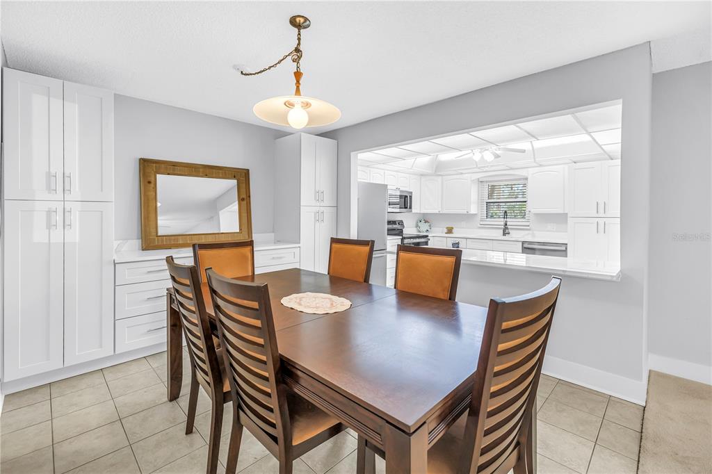 4700 Cove Circle, Unit 103 St. Petersburg, FL 33708 - Photo 13 of 31 a view of a dining room with furniture window and outside view
