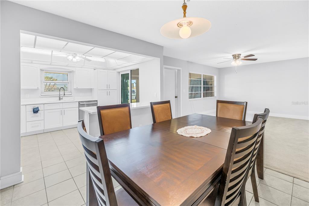 4700 Cove Circle, Unit 103 St. Petersburg, FL 33708 - Photo 15 of 31 a view of a dining room with furniture and a chandelier