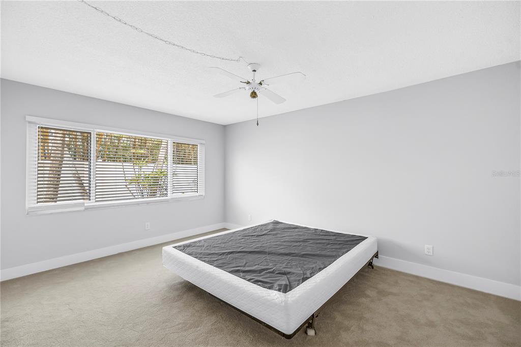 4700 Cove Circle, Unit 103 St. Petersburg, FL 33708 - Photo 22 of 31 an empty room with windows