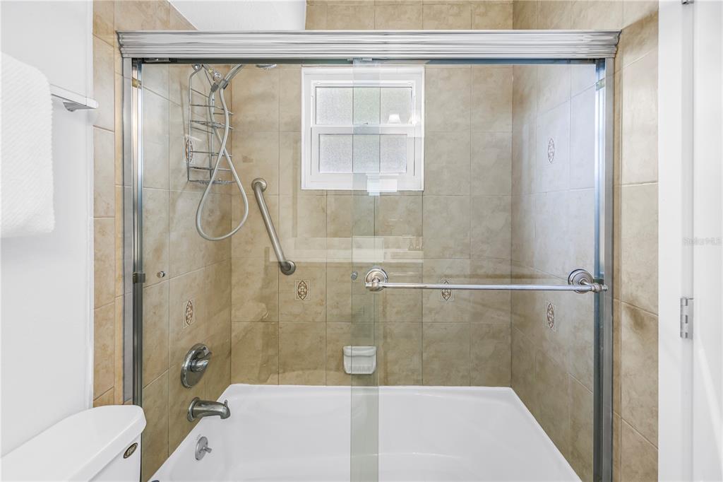 4700 Cove Circle, Unit 103 St. Petersburg, FL 33708 - Photo 25 of 31 a bathroom with a shower and a toilet