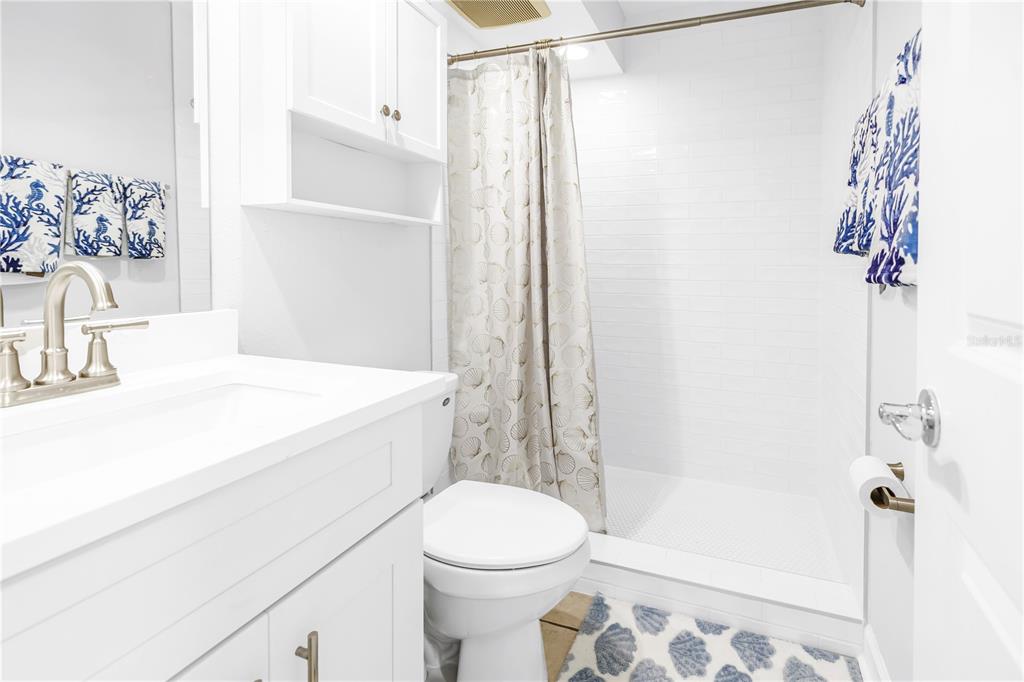 4700 Cove Circle, Unit 103 St. Petersburg, FL 33708 - Photo 27 of 31 a bathroom with a sink toilet and shower