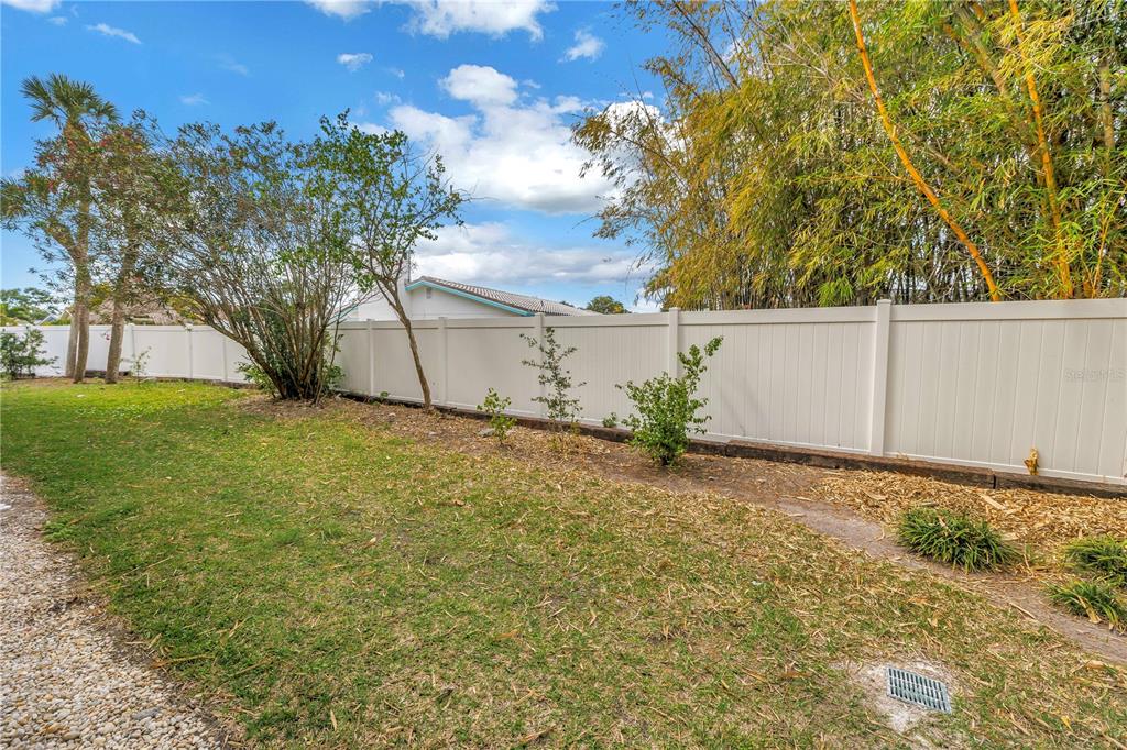 4700 Cove Circle, Unit 103 St. Petersburg, FL 33708 - Photo 28 of 31 a backyard of a house with lots of green space
