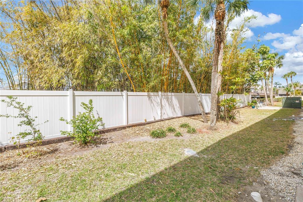 4700 Cove Circle, Unit 103 St. Petersburg, FL 33708 - Photo 31 of 31 a backyard of a house with lots of green space