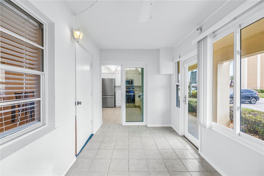 4700 Cove Circle, Unit 103 St. Petersburg, FL 33708 - Photo 6 of 31 a view of an entryway with wooden floor and a window