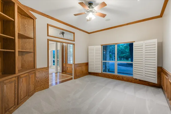 a view of an empty room with a fireplace and window