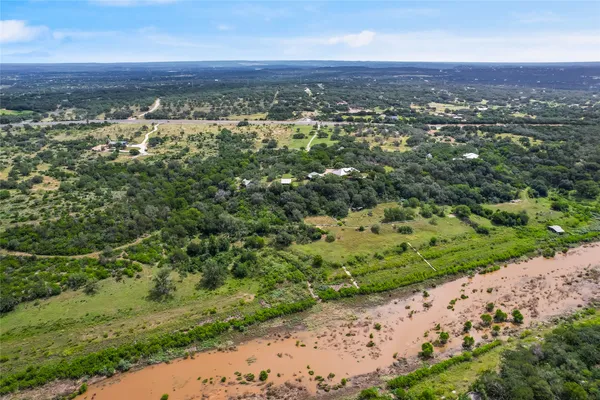 an aerial view of a houses with a yard