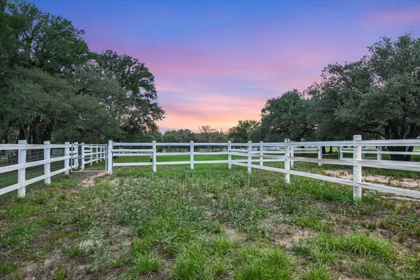 a view of a yard with wooden fence