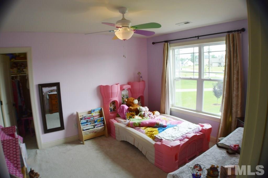 96 South Sunset Ridge Drive Willow Spring, NC 27592 - Photo 22 of 25 a bedroom with a bed and a window