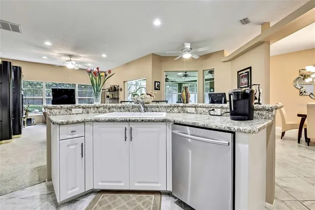 a kitchen with stainless steel appliances granite countertop a sink and cabinets