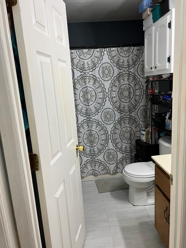 235 Buford Ridley Road Southeast Dalton, GA 30721 - Photo 12 of 21 a bathroom with a toilet and a shower curtain
