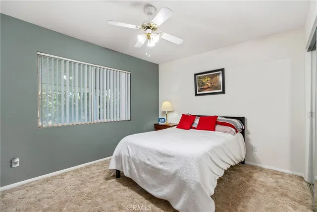 a bedroom with a bed and a window