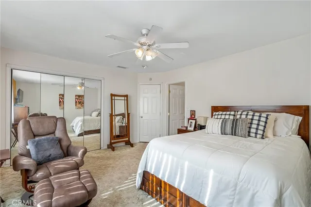 a bedroom with a bed and ceiling fan