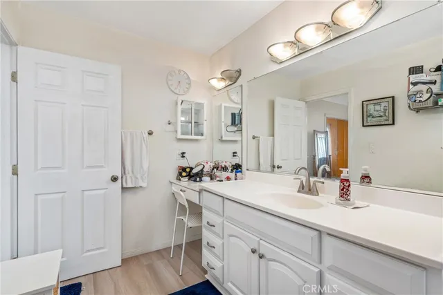 a bathroom with a sink a mirror and a vanity