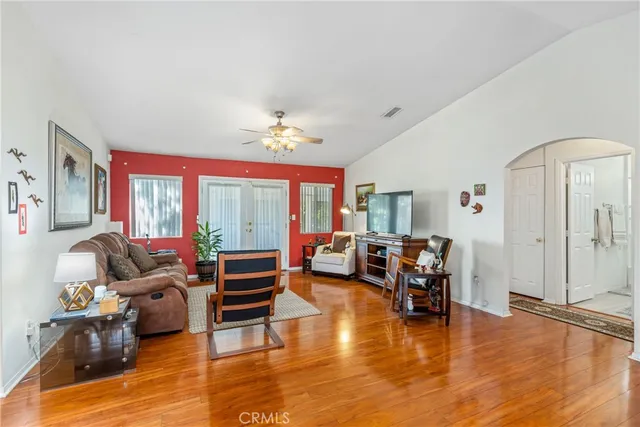 a living room with furniture and wooden floor