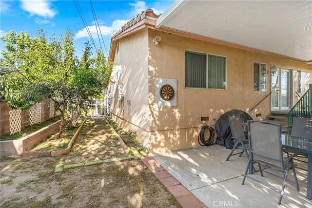 a backyard of a house with outdoor seating