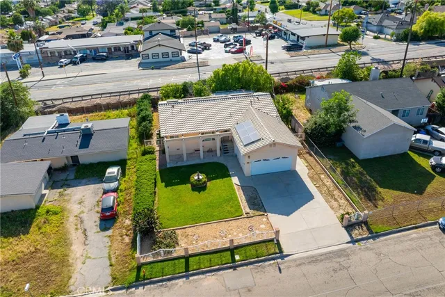 an aerial view of a house with a garden and parking spaces