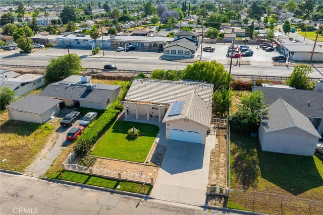 an aerial view of a house with a garden and lake view