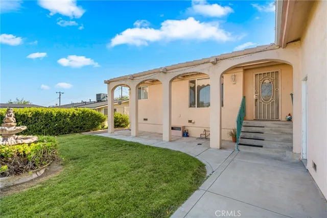 a front view of a house with a garden