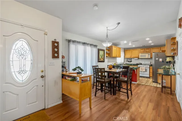a view of a a dining room with furniture window and wooden floor