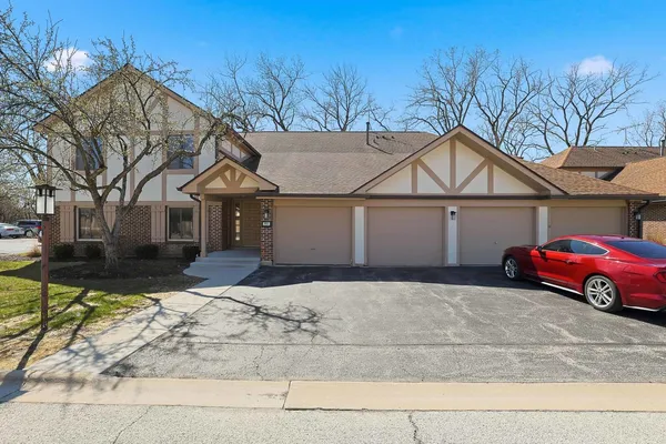 a house that has a tree in front of it